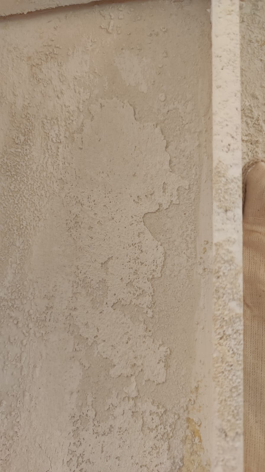 Detail of the chest covering made with crumbling plaster.