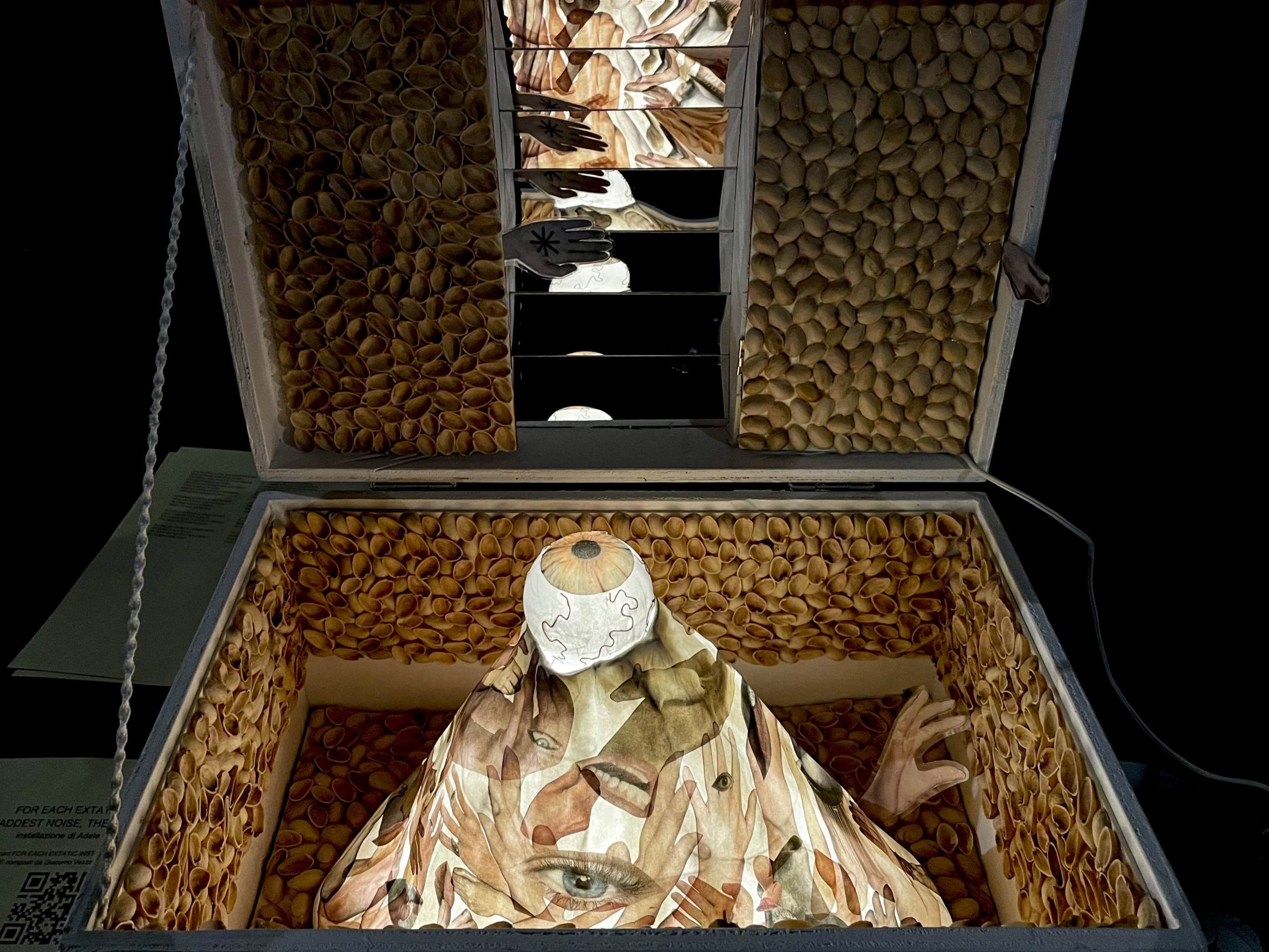 Detail of the illuminated interior of the chest, with mirrors reflecting the main sculpture, creating various facets.